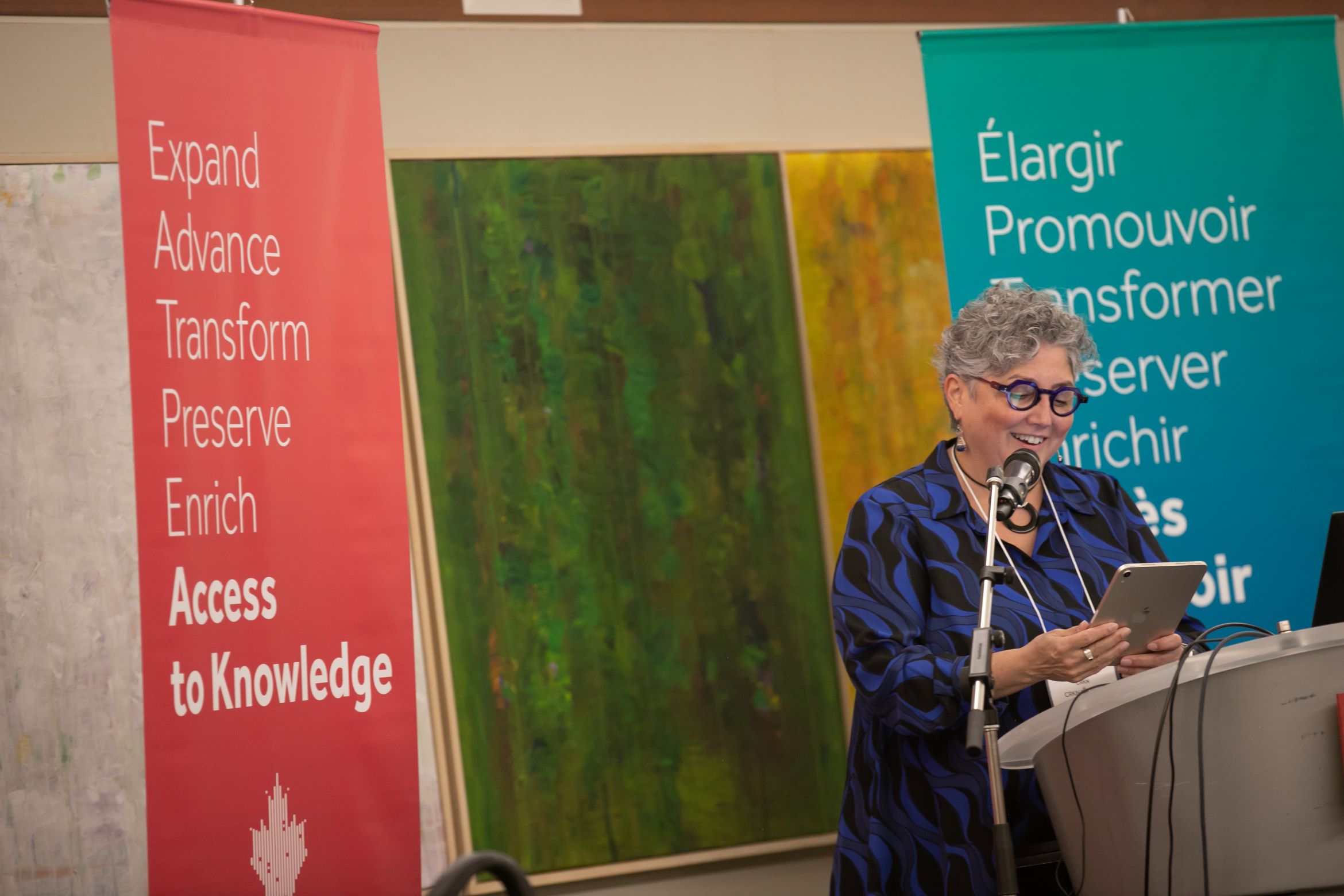 Une photo de Clare Appavoo prononçant un discours lors de la réception du cinquième anniversaire de la fusion.