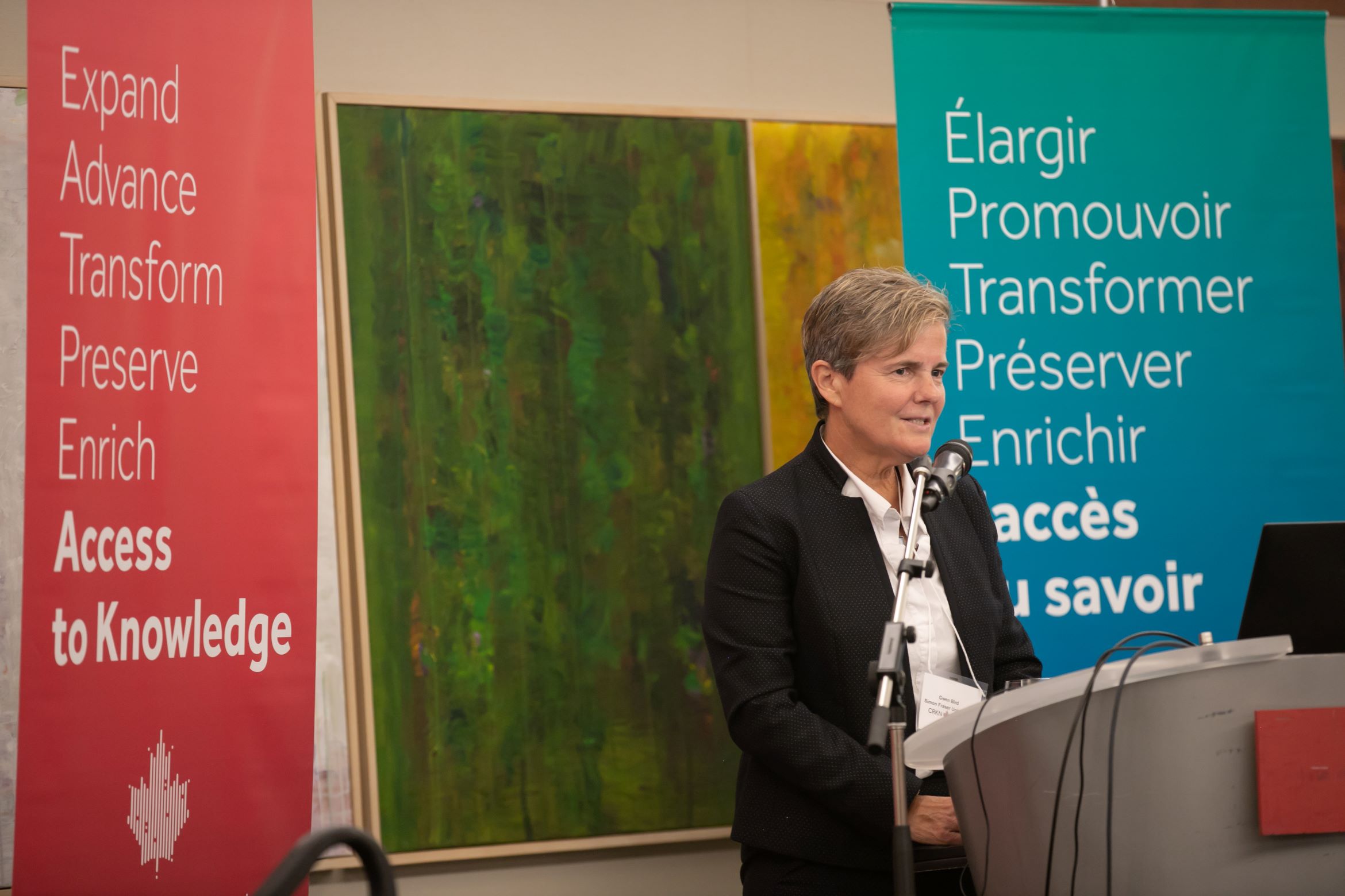 A photo of Gwen Bird delivering a speech during the Five-Year Merger Anniversary Reception.
