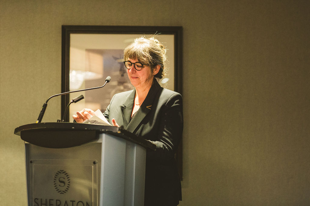 A photo of Guylaine Beaudry delivering a speech during the Ron MacDonald Award Ceremony.
