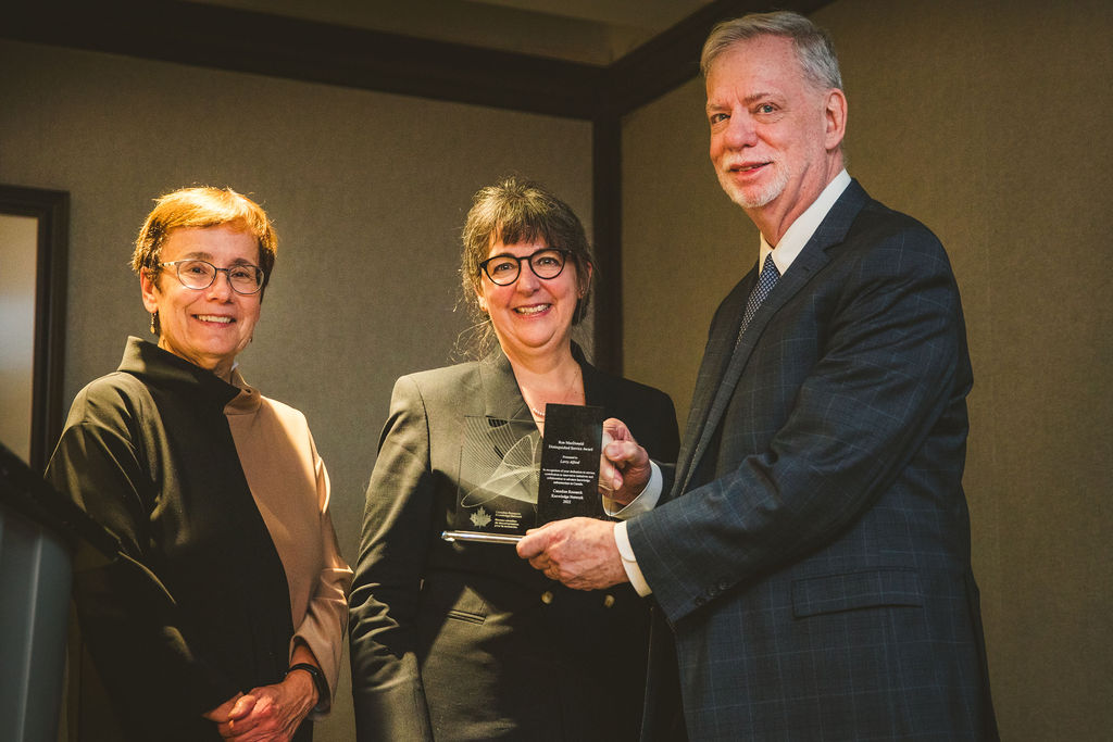 Annette Trimbee, Guylaine Beaudry, and Larry Alford pose with the Ron MacDonald Distinguished Service Award.