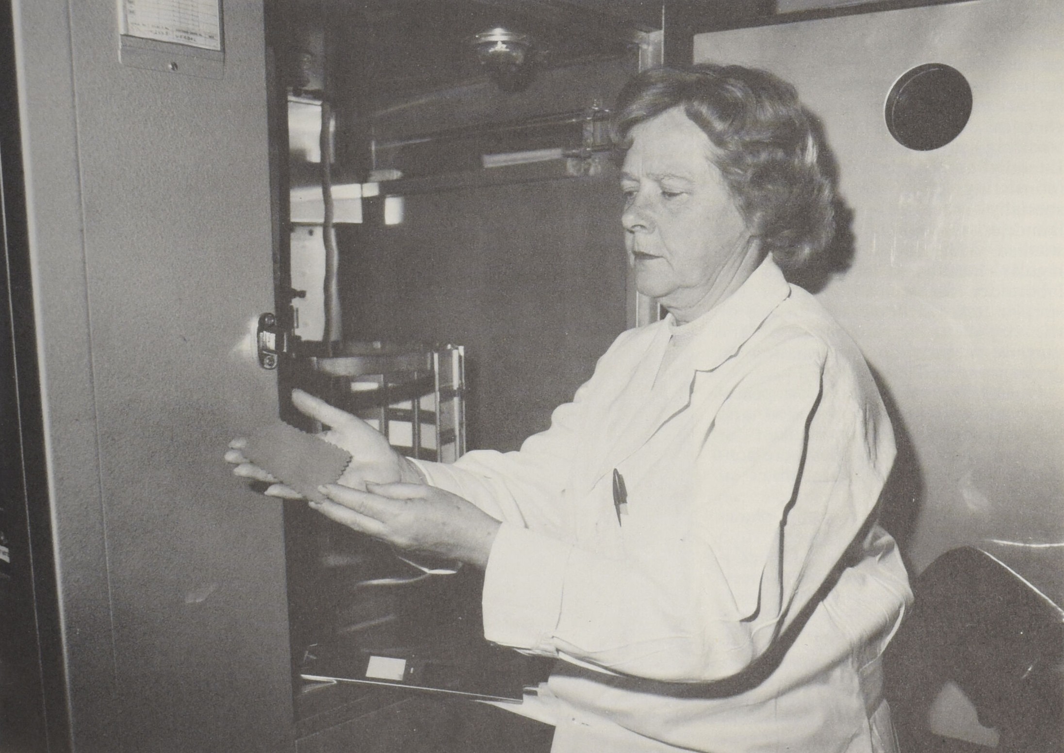 Margaret Mitton displays a fibre example in a lab.